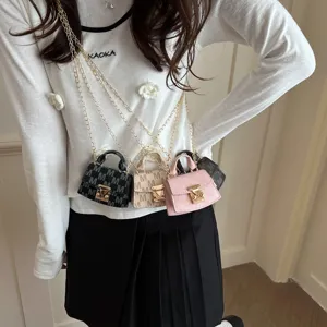 Elegant mini luxury crossbody accessory bags in several colors displayed on a model.