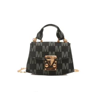 Elegant black mini crossbody bag featuring M monogram print and luxury gold clasp