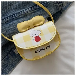 Detalle de mini bolso de cuadros amarillos con estampado de perro y lazo decorativo