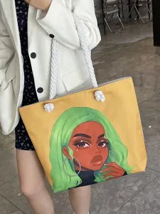 Detalle del bolso tote amarillo con estampado de chica negra y asas de cuerda gruesa