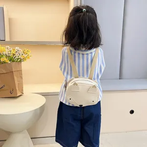Back view of a child wearing a cute cream fox-shaped mini backpack