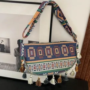 Etnische vintage geweven schoudertas met kleurrijke kwastjes en geometrische patronen