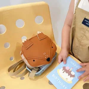 Macro view of a cute fox-shaped orange backpack for kids in a warm lifestyle scene
