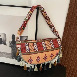 Retro etnische schoudertas met geweven patronen en decoratieve hangende kwastjes