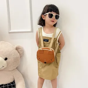 Detailed shot of a cute fox-shaped small backpack for kids worn by a little girl model.