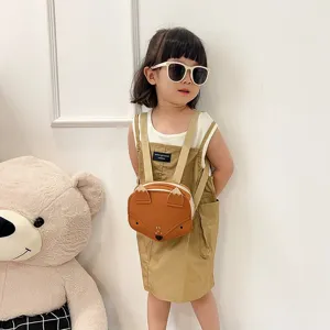 Cute fox-shaped children's backpack worn by a toddler girl with sunglasses.