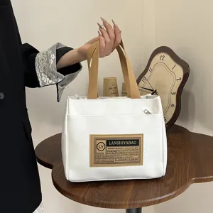 Detail shot of the minimalist Japanese white canvas tote bag for lunch and commuting