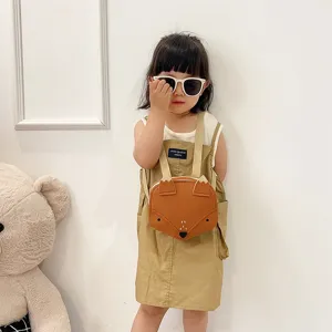 Cute brown fox-shaped children's backpack worn by a toddler in a lifestyle setting