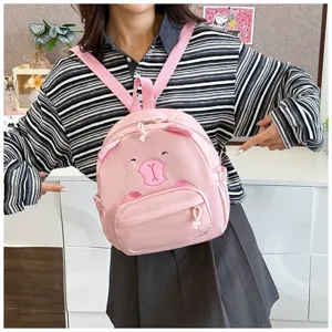 Nahaufnahme eines niedlichen rosa Rucksacks mit Tiermotiv für Mädchen am Modell