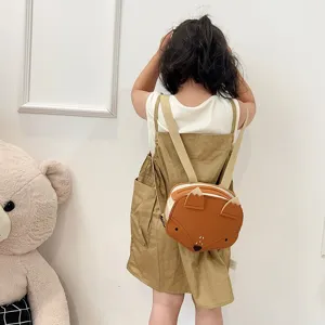 A detailed view showing a child wearing a cute cartoon fox-shaped mini backpack schoolbag