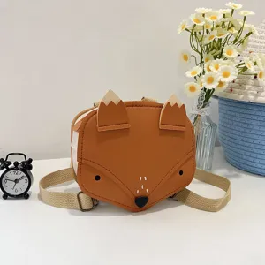 Detailed view of the cute orange fox-shaped children's backpack in a cozy setting