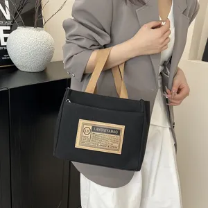 Japanese style black canvas tote bag with khaki handles for commuting or lunch