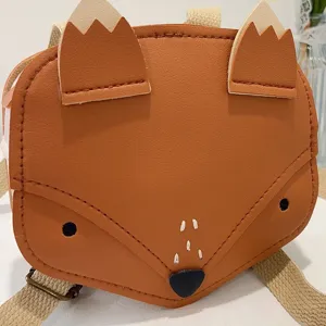 Detailed close-up showing the cute 3D fox face and ears on a children's leather backpack.