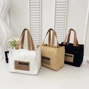 Trio of stylish Japanese canvas tote bags in white, beige, and black for daily use