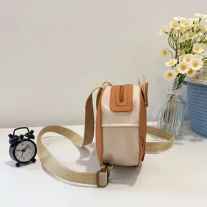 Detailed side view of a cute fox-themed mini backpack for kids in tan and cream colors