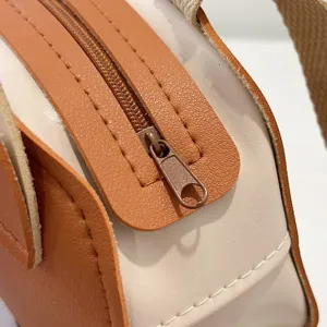 Close-up detail of the smooth zipper and stitching on the children's leather backpack