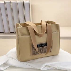 Minimalist beige canvas handbag detail view with a stitched LANSHIYAH patch label