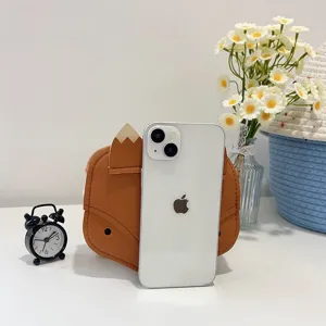 Size comparison of a cute brown fox-shaped mini backpack for kids alongside a smartphone