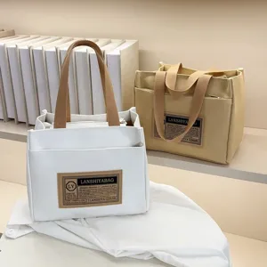Detailed view of high-quality canvas lunch tote bags in minimalist white and beige colors