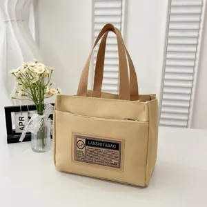 Detailed view of a light yellow Japanese-style canvas tote bag for lunch or daily commute