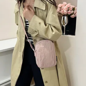 Detalle de bolso bandolera de nailon rosa impermeable y ligero para móvil para mujer