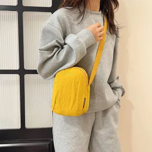Bolso bandolera de nailon amarillo impermeable para mujer en escena casual