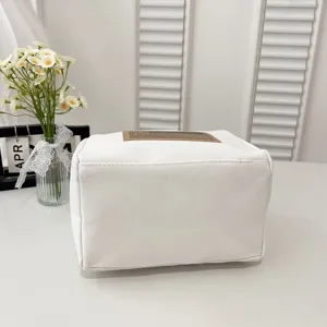 Close-up view of a minimalist white canvas lunch bag with aesthetic prop background