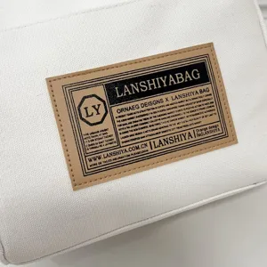 Close-up detail of the vintage label on a minimalist Japanese-style white canvas handbag