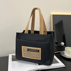 Japanese style black canvas tote bag with woven handles for commuting and lunch bag