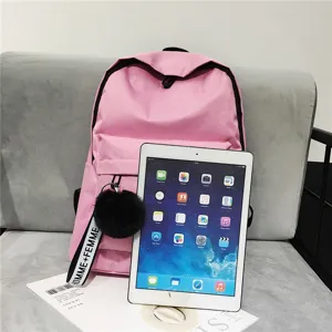 Minimalistischer rosa Canvas-Schulrucksack neben einem weißen Tablet zum Größenvergleich