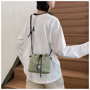 Borsa a secchiello casual in nylon verde oliva con coulisse indossata a tracolla