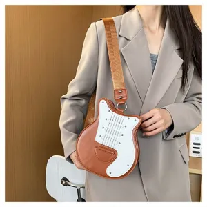 Detail of creative guitar-shaped crossbody bag worn by a model in beige blazer