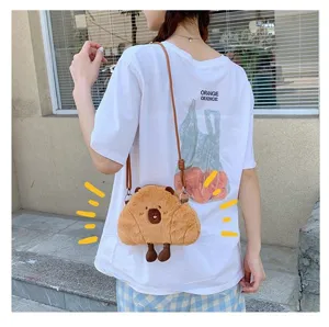 Adorable brown Capybara plush crossbody bag worn by a model in a casual street setting.