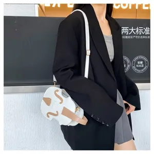 Model wearing a stylish white violin-shaped crossbody bag in a trendy modern café