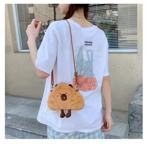 Cute cartoon Capybara plush crossbody bag worn by a model in a casual street setting.
