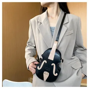 Stylish unique black violin-shaped crossbody bag worn over a beige blazer detail.