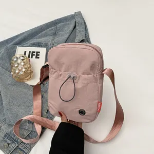 Roze minimalistische nylon schoudertas voor dames, lichte casual crossbody telefoontas.