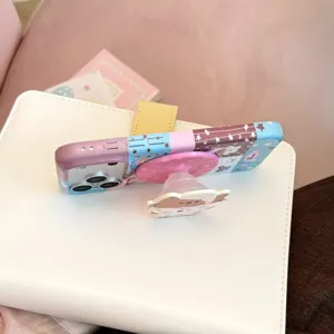 Close-up view of a cartoon cat illustration phone case with a cute bear pop-socket grip