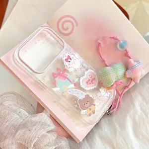 Close-up of transparent iPhone case with cute cartoon bear and rabbit decorations.