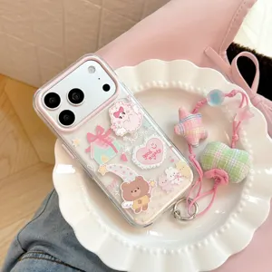Close-up of a cute cartoon bear and rabbit iPhone case with a pink star-shaped strap.