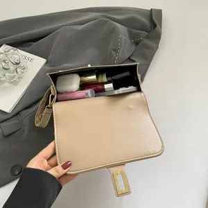 Bolso bandolera pequeño beige para mujer que muestra la capacidad interior y objetos.