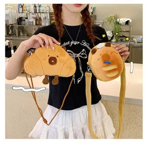 Detail of cute plush capybara crossbody bags in croissant and bun shapes for girls.