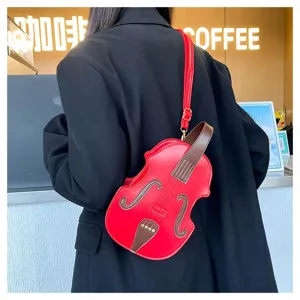 Detail view of a unique red violin shaped crossbody bag worn by a model