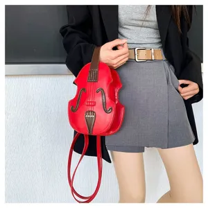 Detail of a violin-shaped red crossbody bag with brown accents and long straps