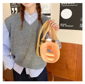 Close-up detail of a cute cartoon plush Capybara crossbody bag held by a model