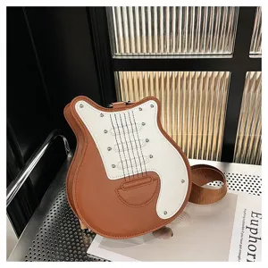 Detailed view of a unique guitar shaped crossbody bag featuring brown and white leather