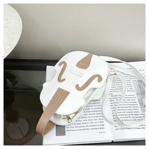 Detailed view of a unique white violin-shaped crossbody bag with elegant beige accents.