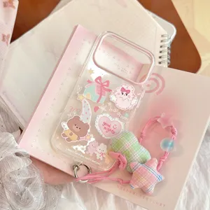 Close-up of transparent iPhone case with cute cartoon rabbit and bear stickers.