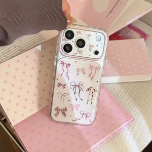 Close-up of a pink leopard bow pattern phone case displayed on a pastel decorative book