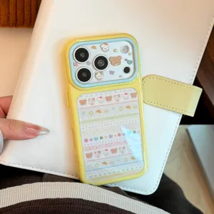 Cute yellow iPhone case with pastel animal patterns on a white leather planner.